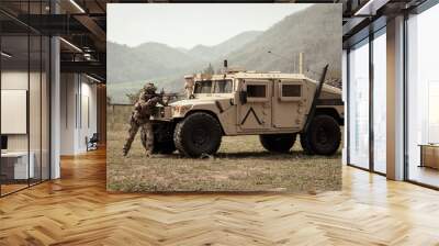 United States Army in camouflage uniforms operation in the forest.with armored vehicle, soldiers training  in a military operation Wall mural