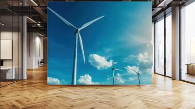 A wind farm with turbines spinning under a clear blue sky, generating clean, renewable energy Wall mural