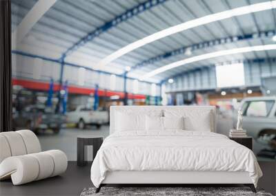 Blurred of Auto mechanic working in Car repair station paved with epoxy floor and electric lift for a car that comes to change the engine oil in the background of Car repair center with epoxy floors. Wall mural