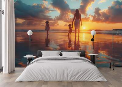 Happy mother and her daughter enjoying walk along beach at sunset. Wall mural