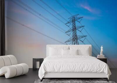 high-voltage power lines, high voltage electric transmission tower for producing electricity at high voltage electricity poles at the sunset. Wall mural