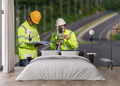 Two surveyor engineers with equipment on road construction site, Civil Engineers, Surveyor equipment. Wall mural