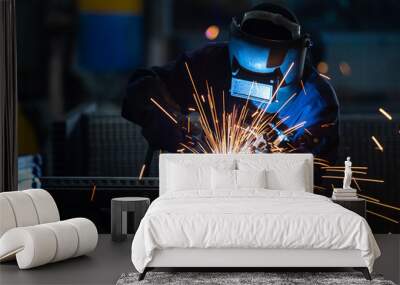 workers wearing industrial uniforms and welded iron mask at steel welding plants, industrial safety  Wall mural