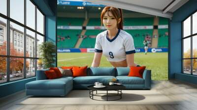 Cheerleader Sitting with Soccer Ball on Field Wall mural