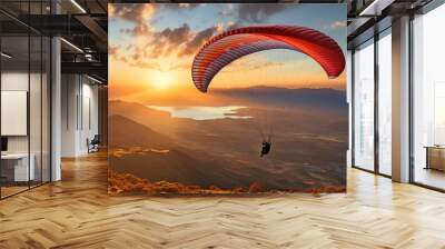 A person paragliding at dusk - A concept of adventure, travel, independence, and thrill sports. Wall mural