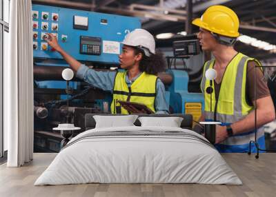 A portrait of a manufacturing worker in discussion with an industrial man and woman engineer holding a tablet in a factory. A Caucasian foreman is in supervision of a CNC machine. Wall mural