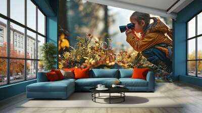 A young person observing the forest and its creatures through binoculars. Wall mural