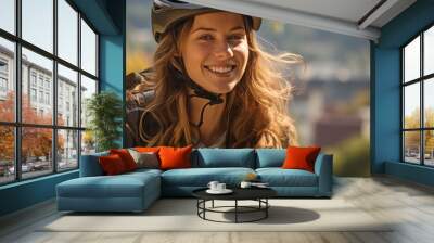 Cycling in an urban park with a smile on her face and a helmet on . Wall mural