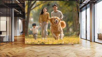 Golden retriever dog having fun in the park with an Asian family Wall mural