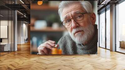 Older man taking a tablet at home Wall mural