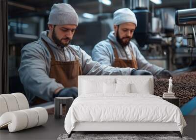 Two uniformed workers placing fresh coffee beans in a bag. Wall mural