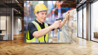 Staff working in large depot storage warehouse hold wireless barcode scanner scan box at shelf Wall mural