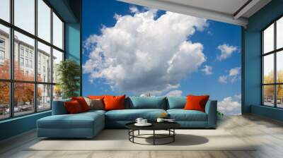 White clouds in the bright blue sky. The beauty of the nature. Wall mural