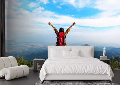 Hiker woman look binoculars on the mountain, background blue sky, Thailand, select and soft focus Wall mural