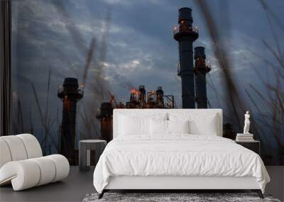 Oil refinery plant chemical factory and power plant with many storage tanks and pipelines at sunset. Wall mural