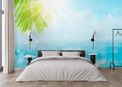 Blur beautiful nature green palm leaf on tropical beach with bokeh sun light wave abstract background. Wall mural