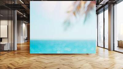 Blur beautiful nature green palm leaf on tropical beach with bokeh sun light wave abstract background. Wall mural