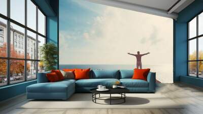 Copy space of man raise hand up on blue sky at beach and island background. Wall mural