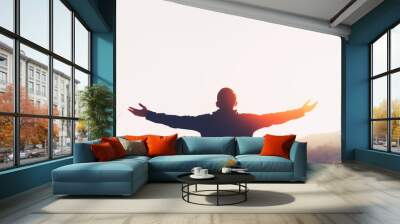 Copy space of man rise hand up on top of mountain and sunset sky abstract background. Wall mural