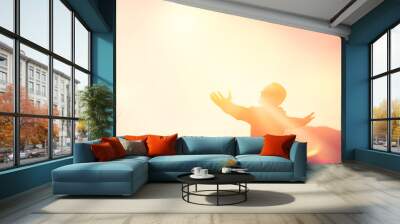 Copy space of man rise hand up on top of mountain and sunset sky abstract background. Wall mural