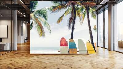 Surfboard and palm tree on beach background. Wall mural