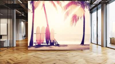 Surfboard and palm tree on beach background. Wall mural