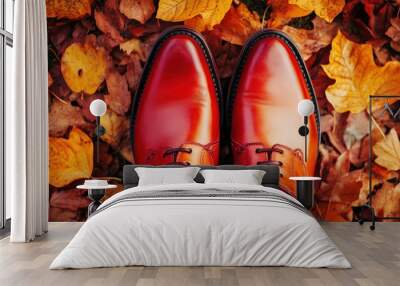 A pair of red leather shoes on a bed of autumn leaves. Wall mural