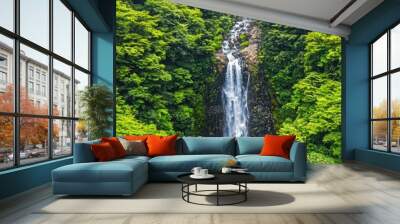 A breathtaking waterfall cascading through lush green foliage, capturing the essence of nature's beauty and serenity in a vibrant landscape. Wall mural