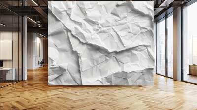 A close-up view of overlapping crumpled white paper sheets in various textures and patterns, creating a dynamic and abstract background. Wall mural