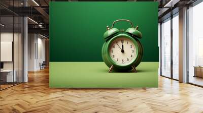 a green alarm clock on a green surface Wall mural