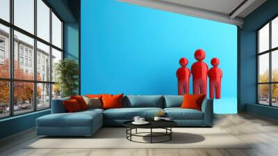 Three red figures stand against a bright blue background, symbolizing unity, teamwork, and family with a minimalist, modern aesthetic. Wall mural