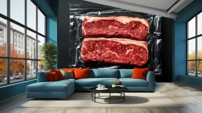 Two vacuum-sealed raw steaks on black background, ready for preparation. Fresh marbled beef perfect for grilling, BBQ, or gourmet recipes. Wall mural