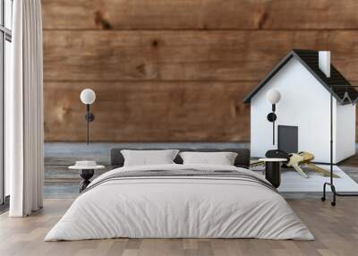 A cozy home model with keys and contract on a wooden table, symbolizing new beginnings and home ownership. Wall mural