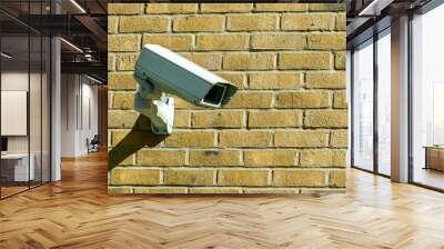 CCTV security camera system being used for surveillance purposes placed on a brick wall with copy space, stock photo image Wall mural