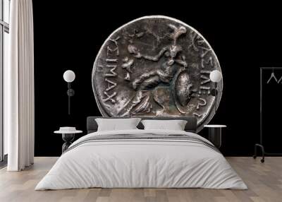 Reverse side of a Greek silver Drachum coin replica of  Alexander the Great dated from 336-323 BC cut out and isolated on a black background, stock photo image Wall mural