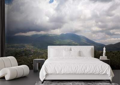 Cloudy sky over Olive tree grove with valley and Taburno-Camposauro mountain massif in the background. Sant’Agata dei Goti in the province of Benevento, Italy. Wall mural