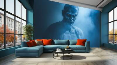 Scary horror demon zombie appearing out of the mist with a evil glint in his eyes  Wall mural