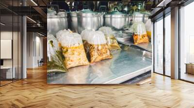 Picture of Thai food stall with plastic bags containing various curry that looks appetizing. Wall mural