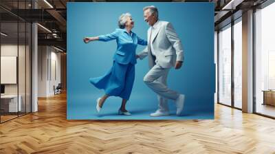 a elderly couple dancing happily and looking to each other in happiness Wall mural