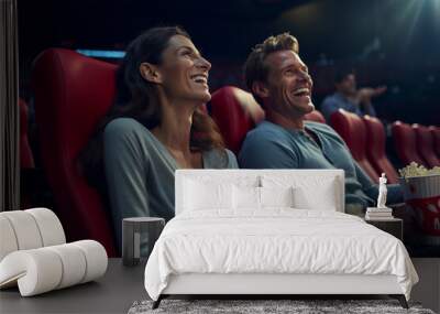 Happy couple with bucket of popcorn in movie theater Wall mural