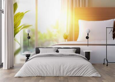 A bed with a white comforter and two pillows Wall mural