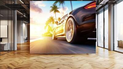 A black car is driving down a road with palm trees in the background Wall mural