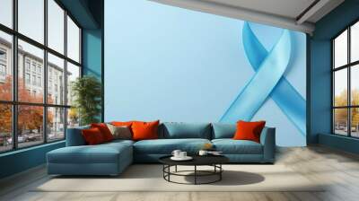 A blue ribbon with a white stripe is displayed on a blue background Wall mural