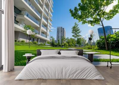 A large apartment building with a green lawn and a tree in front of it Wall mural