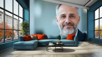 A man with a beard and gray hair is smiling for the camera Wall mural