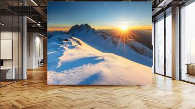 A mountain top covered in snow with sun shining on it Wall mural