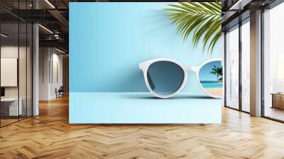 A pair of sunglasses is on a table with a blue background Wall mural