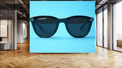 A pair of sunglasses with a black frame and a black lens Wall mural