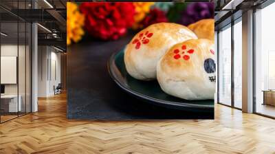 A plate of three decorated pastries with skulls on them Wall mural