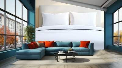 A white bed with two pillows and a white comforter Wall mural